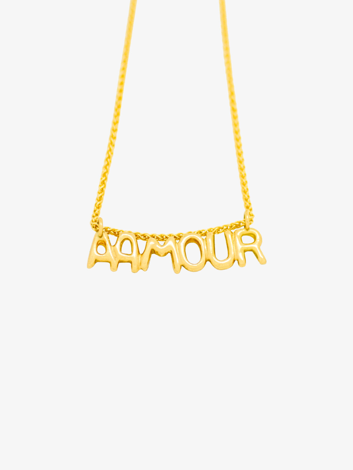 Photography of the 18 K Gold Lettering Pendant Necklace AAMOUR in yellow on grey background with chain.