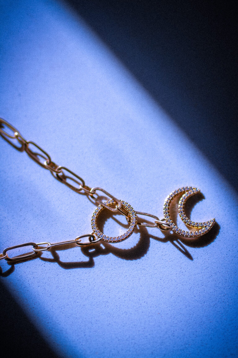 Astra 18 carat necklace on stone background.