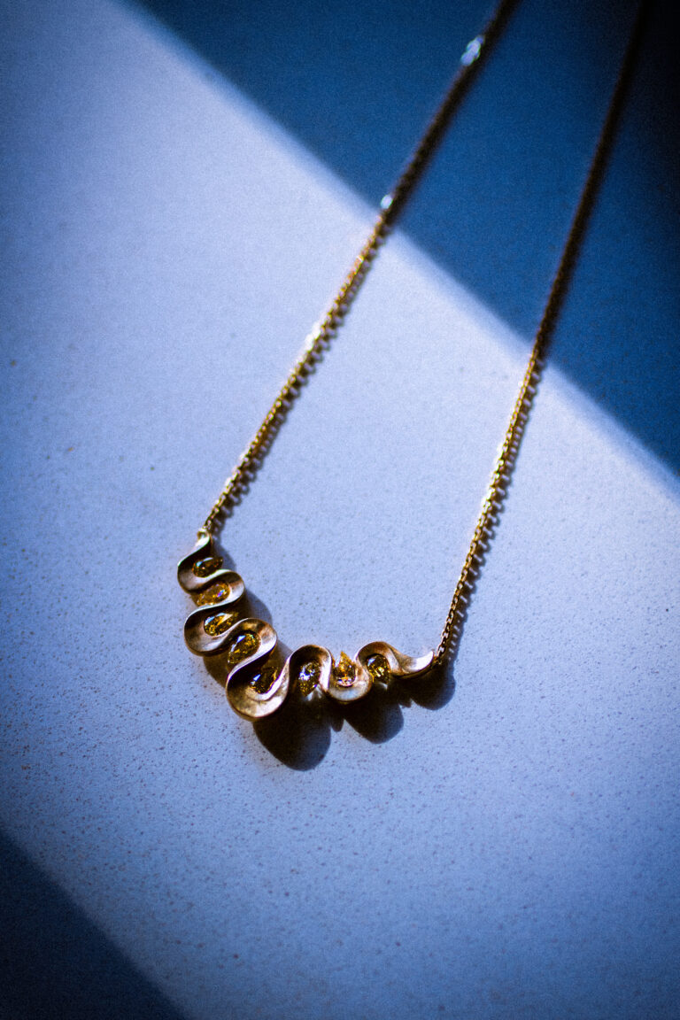 Qualia necklace, 18 carat gold and 8 pear shaped yellow diamonds.