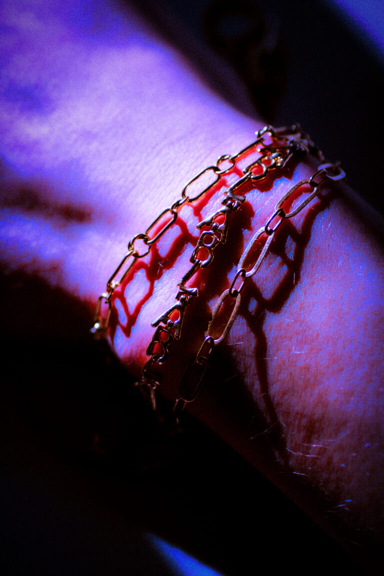 Stack of yellow gold bracelet on male model.