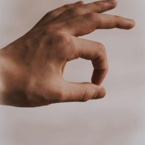 left human hand with OK sign