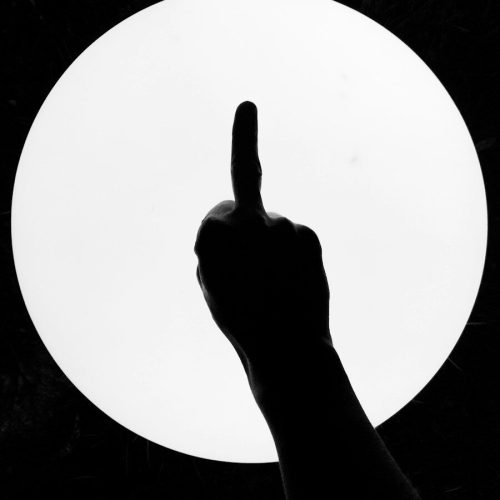 persons right hand raising middle finger